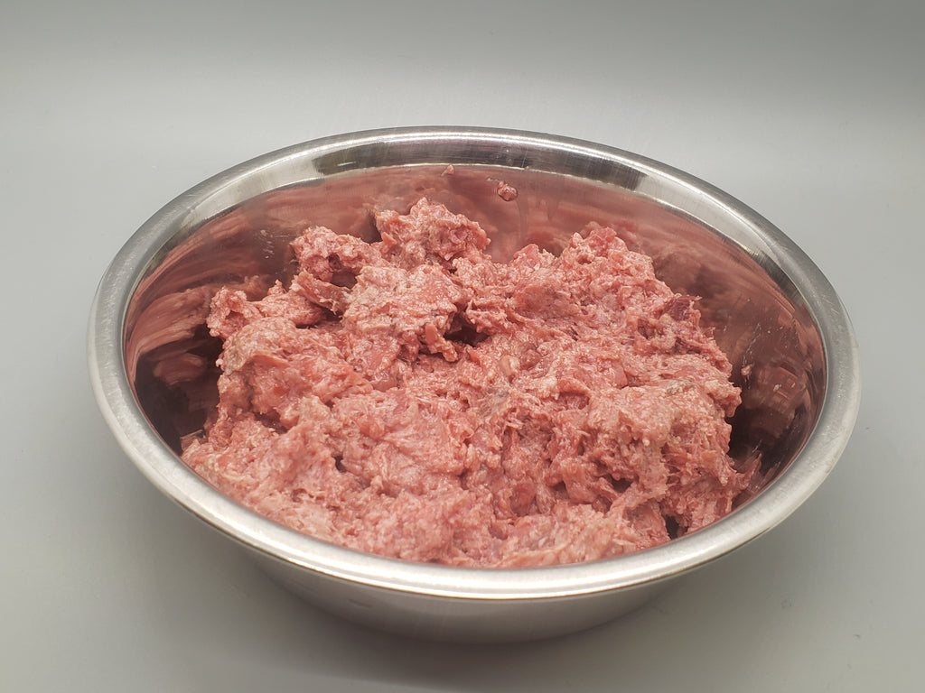 Tube of frozen raw dog food. Ground goose with beef organ and beef tripe. Edmonton raw dog food.