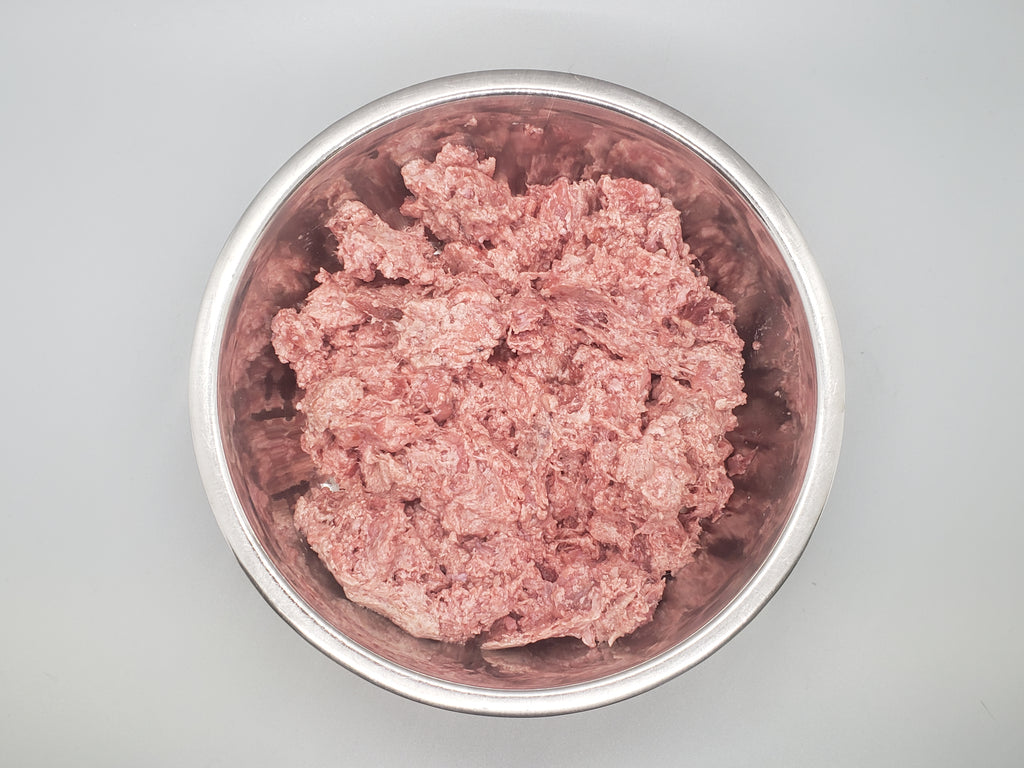 Tube of frozen raw dog food. Ground goose with beef organ and beef tripe. Edmonton raw dog food.
