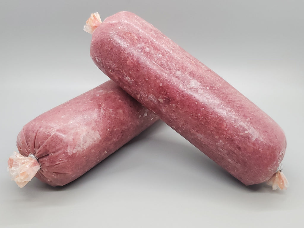 Tube of frozen raw dog food. Ground chicken with bone and chicken organs. Edmonton raw dog food.