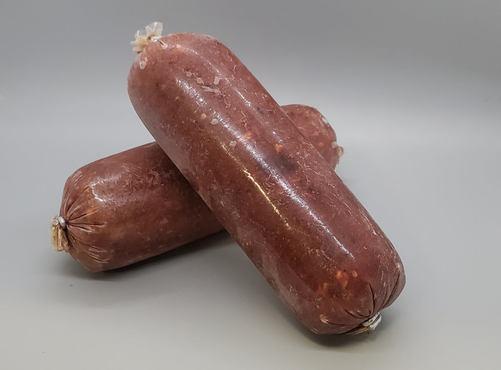 Tube of frozen raw dog food. Ground salmon with pork muscle meat and beef organ and beef tripe. Edmonton raw dog food.