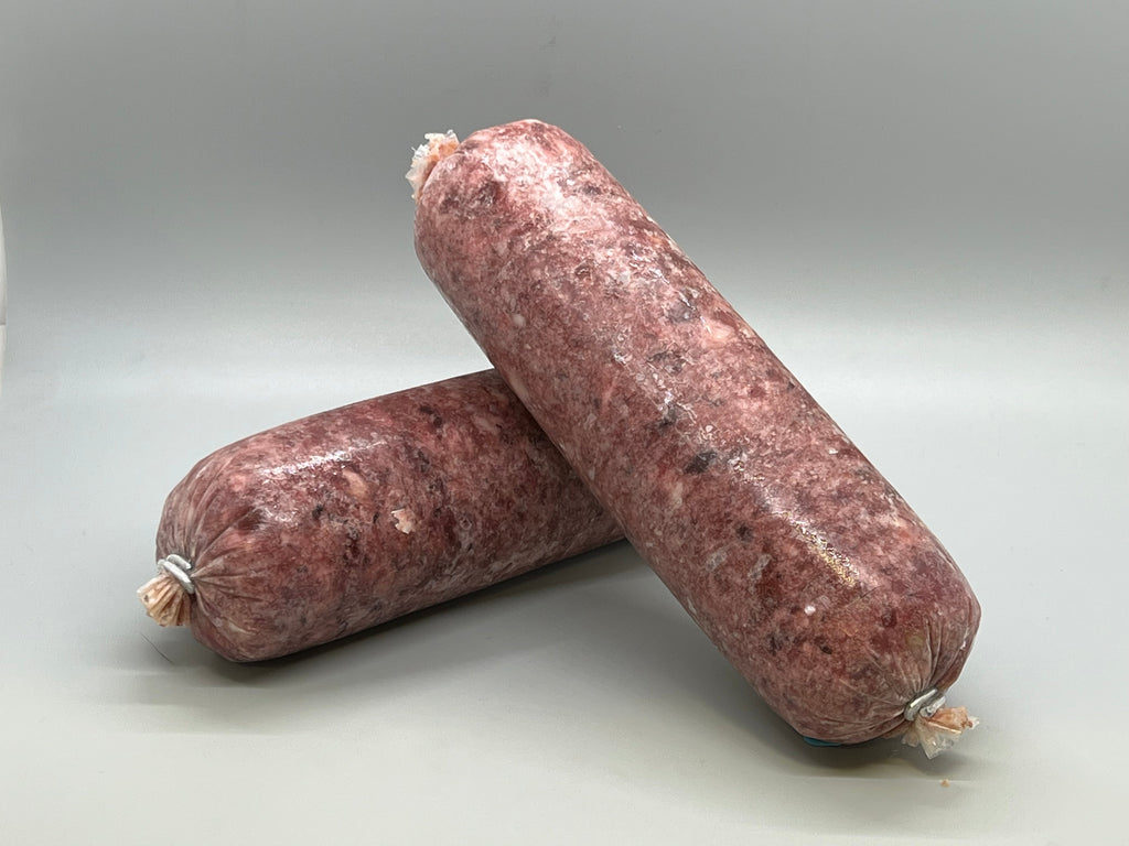 Tube of frozen raw dog food. Ground chicken with bone, beef muscle meat, pork muscle meat, salmon and beef tripe. Edmonton raw dog food.